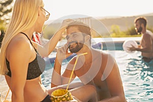 Couple at a swimming pool party