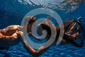 Couple swimming underwater