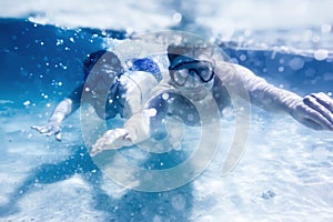 Couple swims or snorkeling underwater