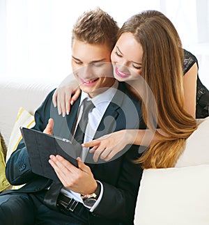 Couple with tablet pc chatting or buying online