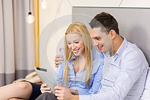 Couple with tablet pc computer in hotel room