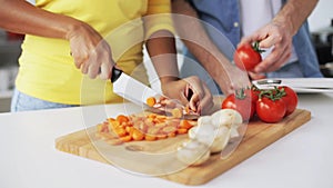 Couple with tablet pc cooking food at home