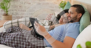 Couple, tablet and scroll in bed, morning and bond with internet video, movie and meme for love, care and hug. Man
