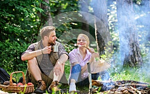 Couple take break to eat nature background. Couple in love camping forest hike. Food for hike and camping. Couple sit