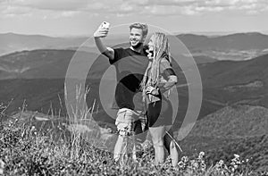 Couple taking photo. Couple in love hiking mountains. Lets take photo. Capturing beauty. Man and woman posing mobile