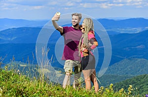 Couple taking photo. Couple in love hiking mountains. Lets take photo. Capturing beauty. Man and woman posing mobile