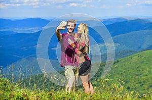 Couple taking photo. Summer vacation concept. Young adventurers. Travel together with darling. Couple in love hiking