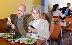 Couple taking photoes of meal