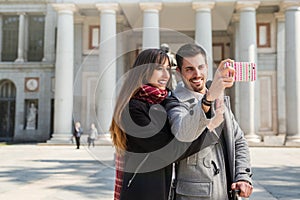 Couple taking pictures at prado museum madrid
