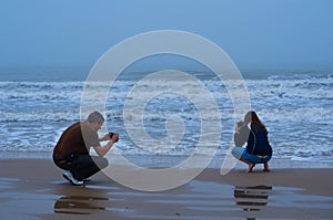 Couple Taking Pictures of the Surf