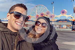 Couple taking a selfie in coney island. Luna park as background