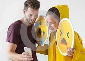 Couple taking selfie with emojis