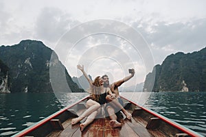 Couple taking selfie on a longtail boat