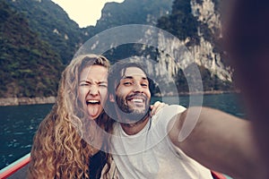 Couple taking selfie on a longtail boat