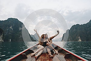 Couple taking selfie on a longtail boat photo