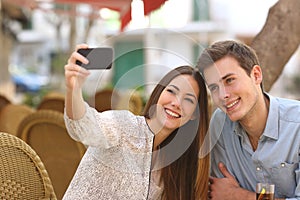 Couple taking a selfie photo in a restaurant