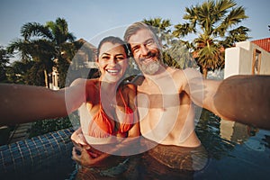 Couple taking a selfie in a pool