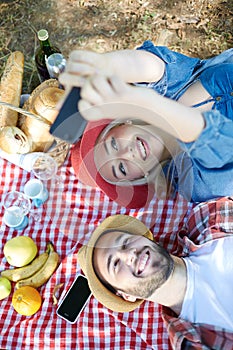 Couple taking selfie on romantic picnic