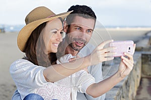 couple taking selfie by sea