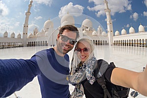 Couple taking selfie in Sheikh Zayed Grand Mosque, Abu Dhabi, United Arab Emirates.