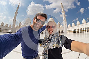 Couple taking selfie in Sheikh Zayed Grand Mosque, Abu Dhabi, United Arab Emirates.