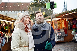 Couple taking selfie with smartphone in old town