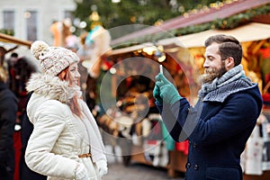 Couple taking selfie with smartphone in old town