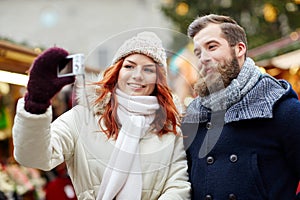 Couple taking selfie with smartphone in old town