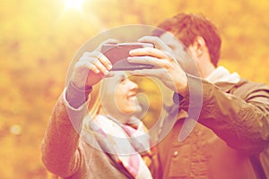 Couple taking selfie with smartphone in park