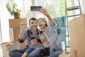 Couple taking selfie in their new apartment