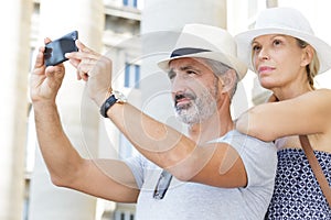 Couple taking selfportrait with smartphone