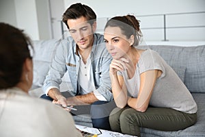 Couple talking with architect about construction plan