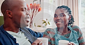 Couple, talking and laughing on couch with coffee for relax, bonding and funny conversation in living room of home