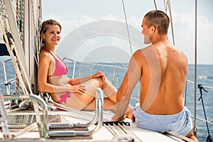 Couple talking on pleasure yacht deck