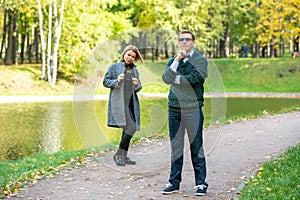 Couple talking seriously outdoors in a park with a green background