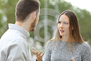 Couple talking seriously outdoors