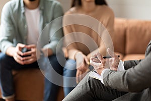 Couple talking at session with male therapist