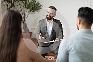 Couple talking at therapy session with male therapist