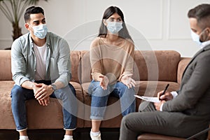 Couple talking at therapy session with professional male therapist