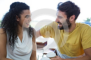 Couple talking to each other in coffee shop