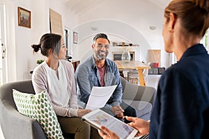 Couple talking to financial advisor at home