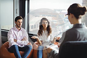 Couple talking to a marriage counselor during therapy