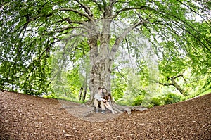 Couple talking under a big tree