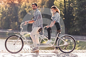 Couple with a tandem bicycle