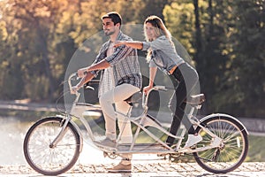 Couple with a tandem bicycle