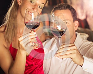 Couple tasting red wine in cellar at winetasting