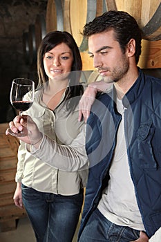Couple tasting wine in cellar