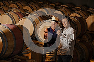 Couple tasting wine in a cellar