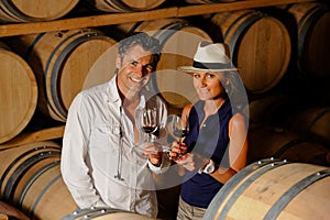 Couple tasting wine in a cellar