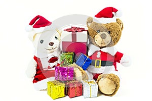Couple teddy bear doll wearing santa set with many colorful gift boxes isolated on white background,Christmas day and New Year`s